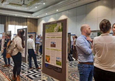 Participants engage in discussions during a poster walk session at the European Legumes Congress, showcasing research on sustainable legume farming and breeding